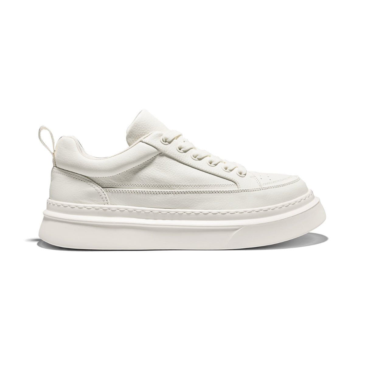 Minimalist thick-sole trainers in off-white, mixed-material design with round toe and lace-up closure.